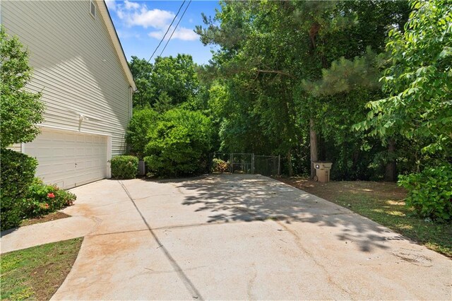 90 Cypress Dr, Covington, GA 30016 - view of patio featuring driveway and a garage