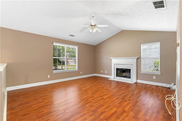 90 Cypress Dr, Covington, GA 30016 - unfurnished living room featuring wood finished floors, ceiling fan, lofted ceiling, a premium fireplace, and baseboards