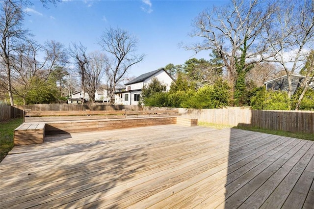 wooden terrace featuring a fenced backyard