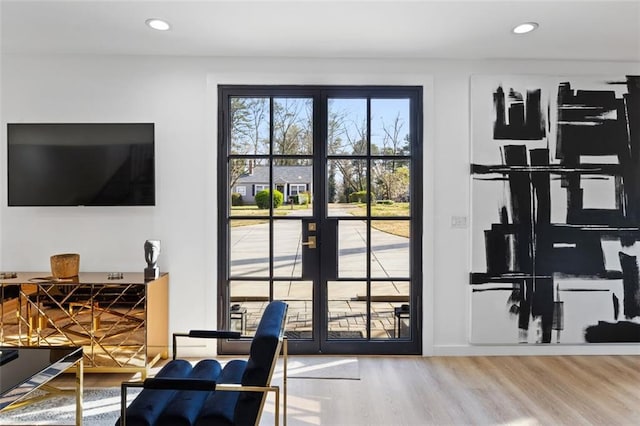 doorway to outside featuring recessed lighting, wood finished floors, and french doors