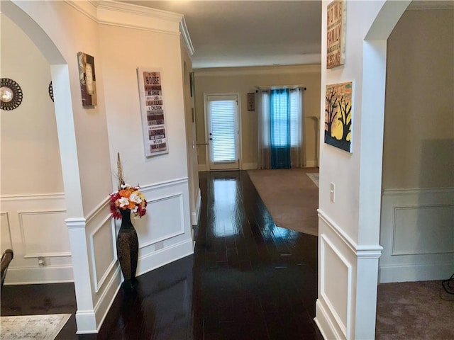 corridor with dark wood-type flooring and ornamental molding