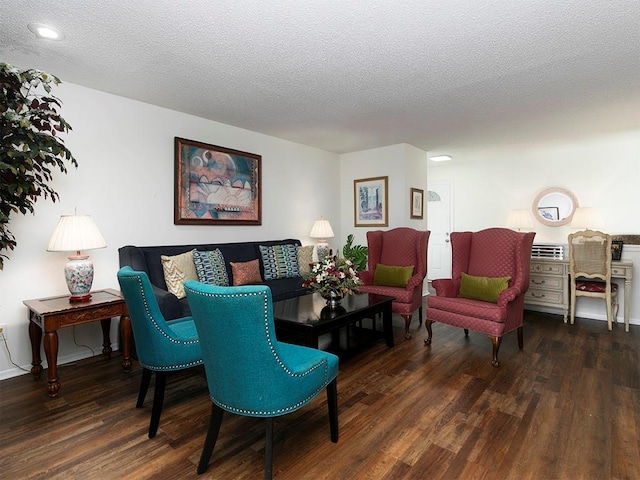 living room with dark hardwood / wood-style floors and a textured ceiling