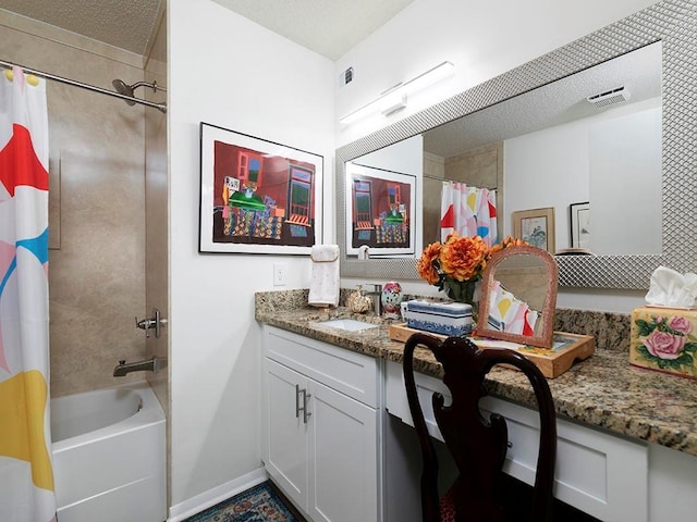 bathroom with vanity, shower / tub combo, and a textured ceiling