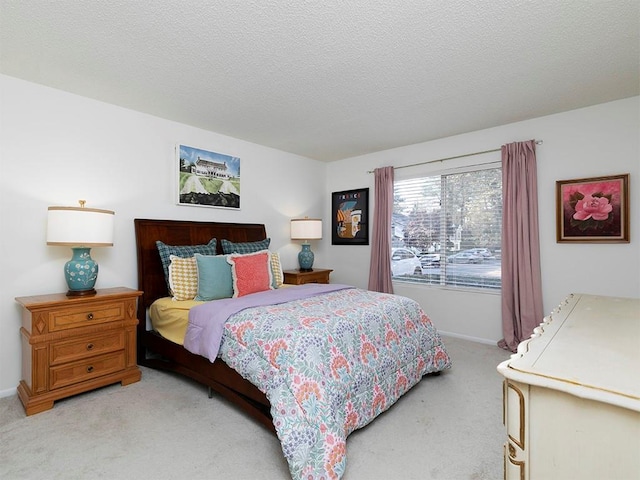 bedroom with carpet floors and a textured ceiling