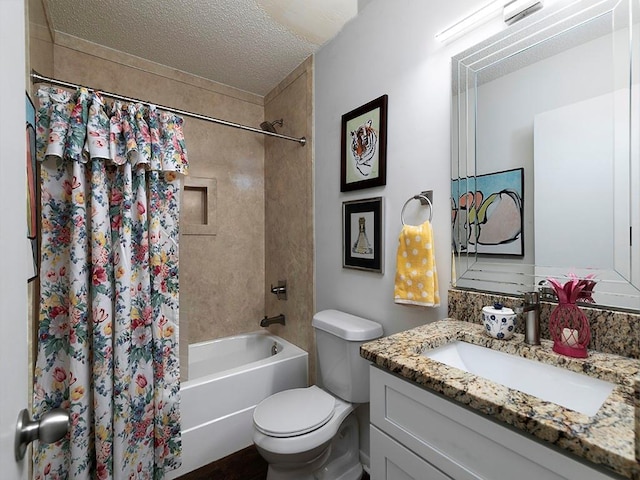 full bathroom with shower / tub combo with curtain, vanity, toilet, and a textured ceiling