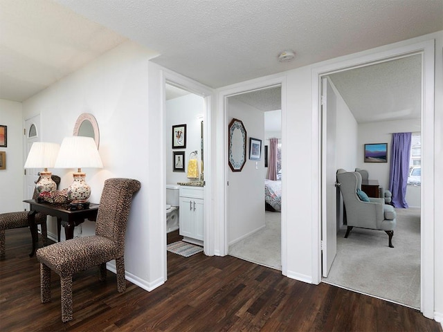 interior space with dark wood-type flooring and a textured ceiling