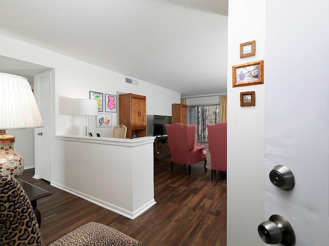 interior space featuring dark hardwood / wood-style floors and a textured ceiling