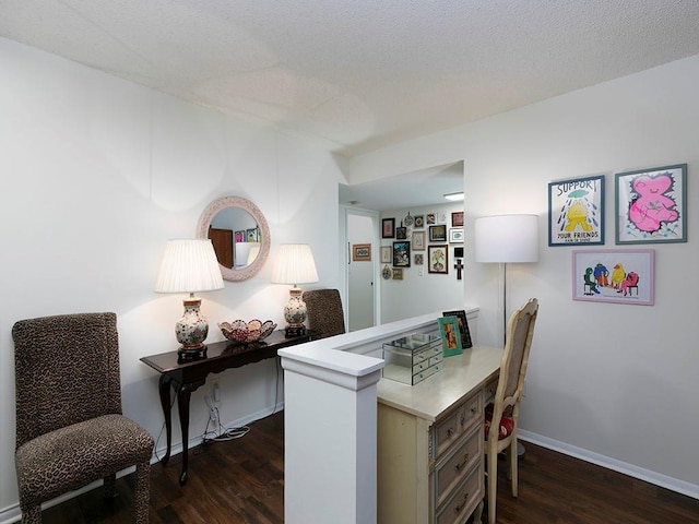 home office featuring dark hardwood / wood-style floors and a textured ceiling