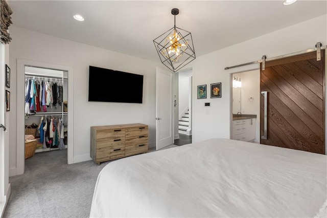 307 Cedar Dust Dr, Decatur, GA 30030 - bedroom featuring a barn door, a walk in closet, carpet flooring, a closet, and recessed lighting