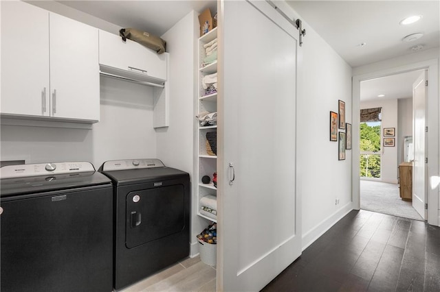 307 Cedar Dust Dr, Decatur, GA 30030 - laundry room featuring independent washer and dryer, wood finished floors, cabinet space, a barn door, and baseboards