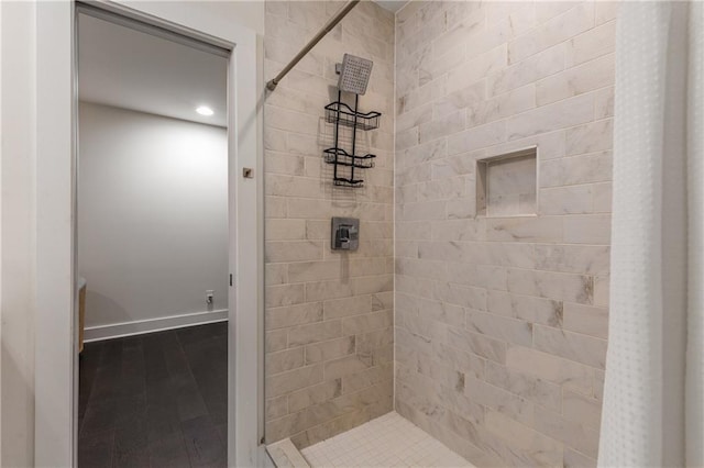 307 Cedar Dust Dr, Decatur, GA 30030 - bathroom featuring a tile shower, baseboards, and wood finished floors
