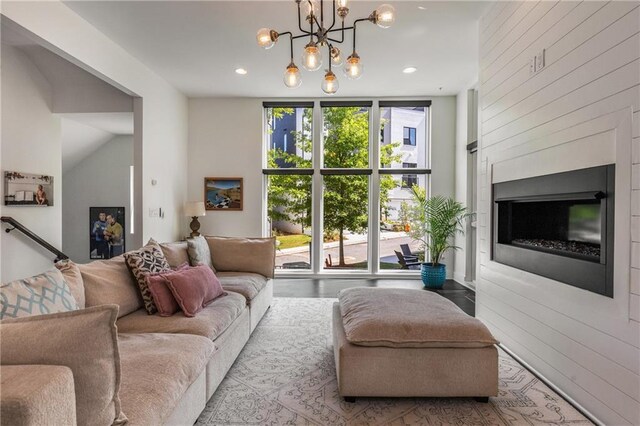 307 Cedar Dust Dr, Decatur, GA 30030 - living area featuring recessed lighting, a chandelier, wood walls, a glass covered fireplace, and expansive windows