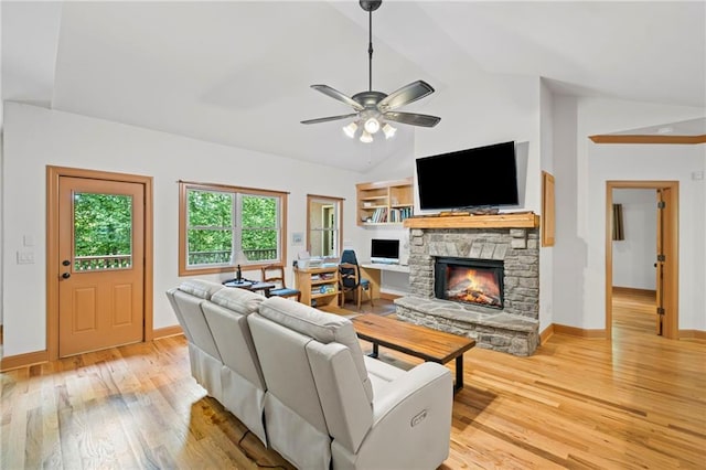 6324 Chesla Dr, Gainesville, GA 30506 - living area with light wood-style floors, ceiling fan, a fireplace, baseboards, and high vaulted ceiling
