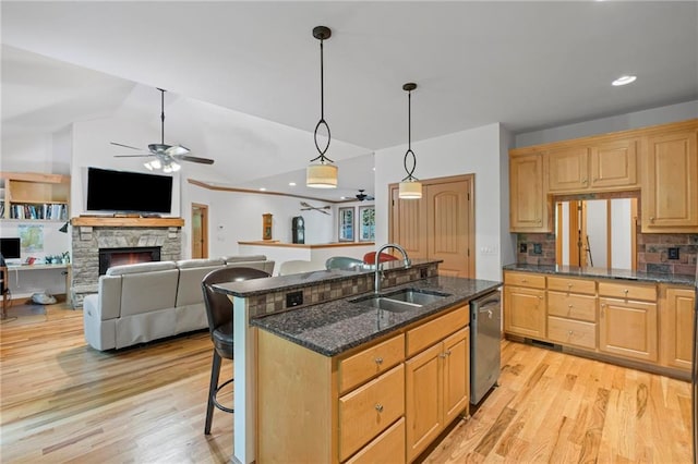 6324 Chesla Dr, Gainesville, GA 30506 - kitchen with a sink, ceiling fan, dishwasher, a breakfast bar area, and light wood-style flooring