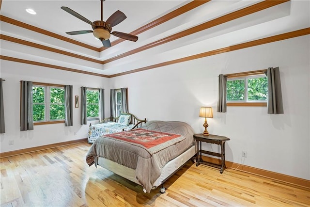6324 Chesla Dr, Gainesville, GA 30506 - bedroom with multiple windows, a raised ceiling, baseboards, wood finished floors, and crown molding
