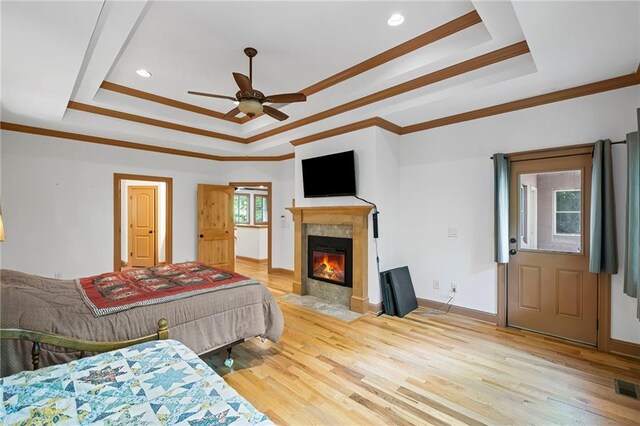 6324 Chesla Dr, Gainesville, GA 30506 - bedroom featuring a raised ceiling, light wood-style floors, a fireplace, ornamental molding, and baseboards