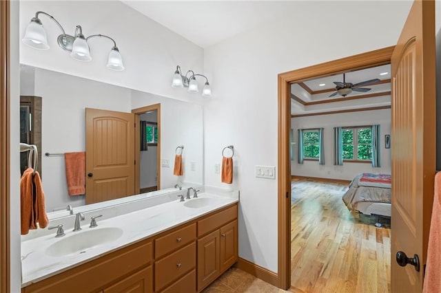 6324 Chesla Dr, Gainesville, GA 30506 - ensuite bathroom featuring ceiling fan, double vanity, baseboards, wood finished floors, and ornamental molding
