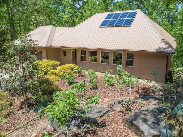 6324 Chesla Dr, Gainesville, GA 30506 - rear view of property featuring stucco siding, roof mounted solar panels, and metal roof