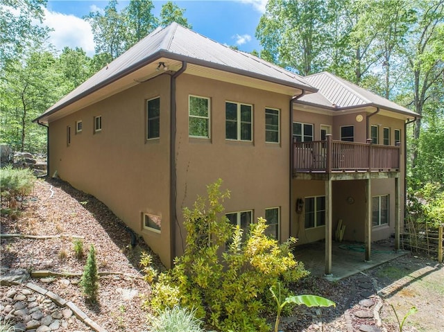 6324 Chesla Dr, Gainesville, GA 30506 - view of side of property with stucco siding, metal roof, a balcony, and a patio area