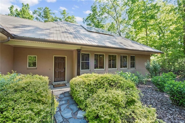 6324 Chesla Dr, Gainesville, GA 30506 - property entrance with stucco siding, metal roof, and covered porch