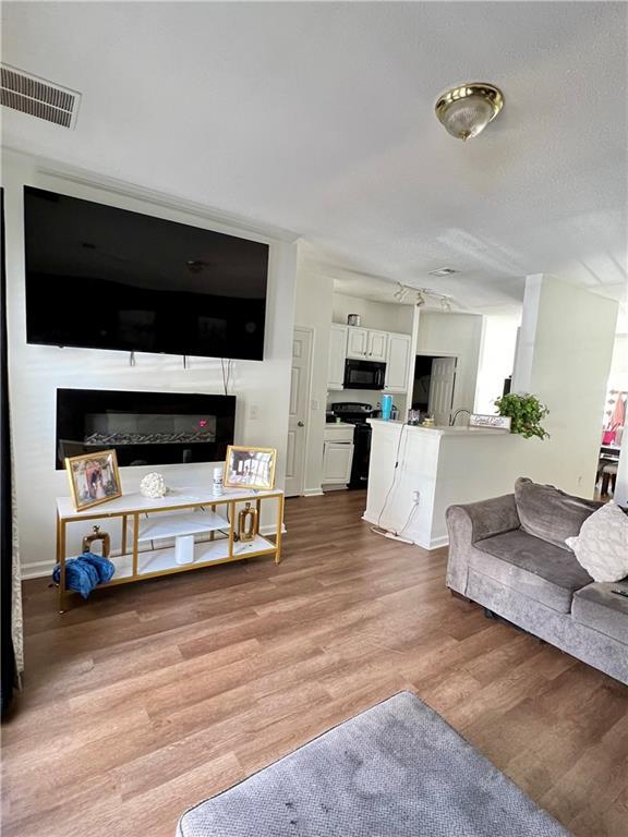 1731 Pryor Rd SW Unit 307, Atlanta, GA 30315 - living room with light wood-style floors