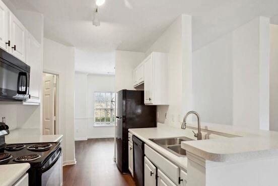 1731 Pryor Rd SW Unit 307, Atlanta, GA 30315 - kitchen featuring black appliances, dark wood-style flooring, light countertops, and white cabinets