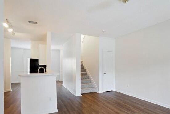 1731 Pryor Rd SW Unit 307, Atlanta, GA 30315 - unfurnished living room featuring stairs and dark wood finished floors