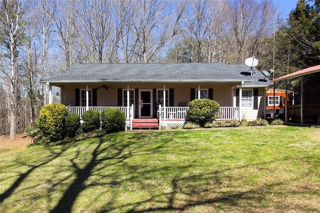 ranch-style home with a front yard, covered porch, and ceiling fan