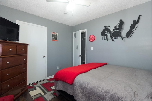 bedroom with ceiling fan and a textured ceiling