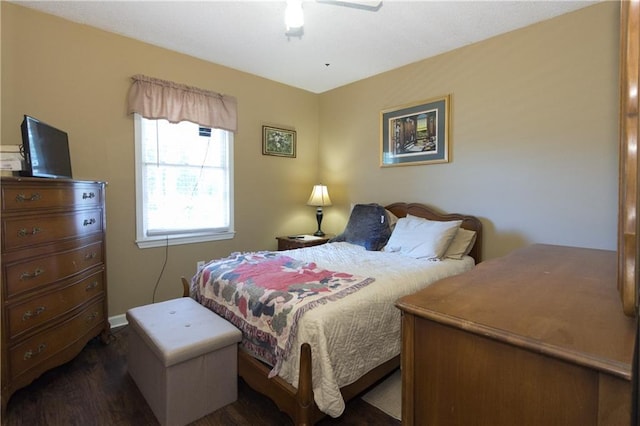 bedroom featuring dark wood-style floors, ceiling fan, and baseboards