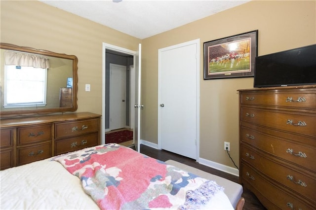 bedroom with a closet and baseboards