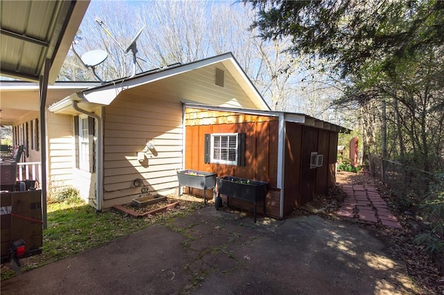 view of side of home with a patio area