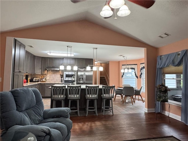 714 Arden Dr, Winder, GA 30680 - living area featuring a ceiling fan, vaulted ceiling, stairs, and light wood finished floors
