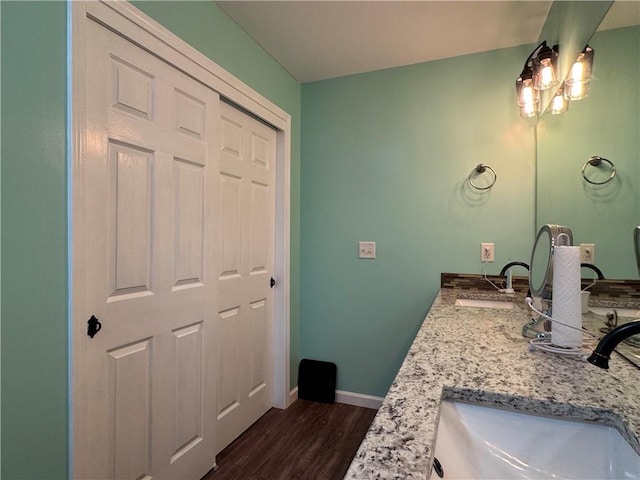 714 Arden Dr, Winder, GA 30680 - bathroom with wood finished floors, double vanity, and baseboards