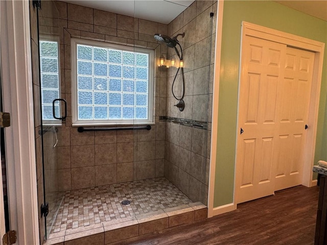 714 Arden Dr, Winder, GA 30680 - bathroom featuring a shower stall, wood finished floors, and baseboards