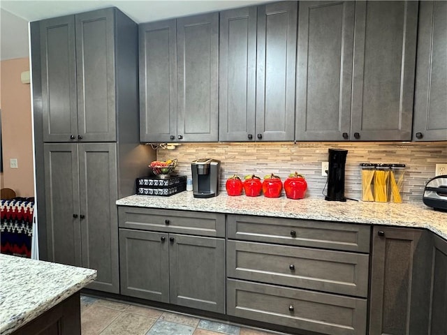 714 Arden Dr, Winder, GA 30680 - kitchen featuring backsplash, light stone counters, and gray cabinetry