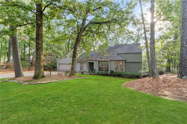 ranch-style house featuring a garage and a front lawn