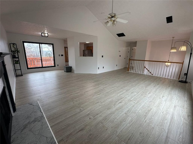 unfurnished living room with ceiling fan, light hardwood / wood-style flooring, and high vaulted ceiling