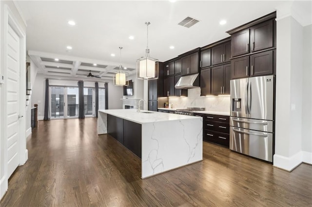 kitchen with dark wood-style floors, coffered ceiling, a sink, under cabinet range hood, and appliances with stainless steel finishes