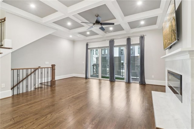 unfurnished living room with a fireplace, wood finished floors, and baseboards