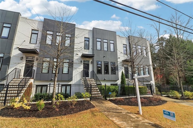 view of front of property with a fenced front yard and stucco siding