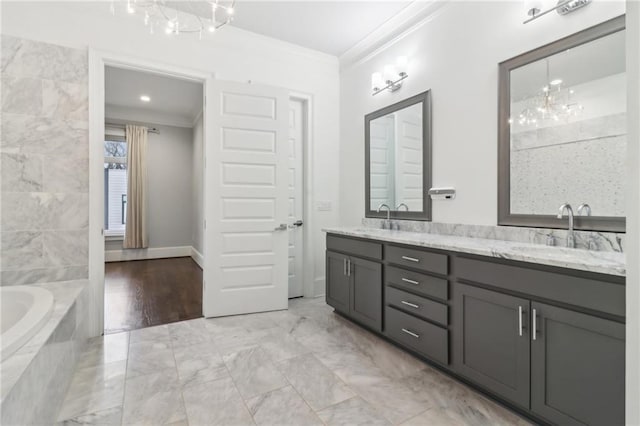 bathroom featuring a sink, double vanity, a tub, and crown molding