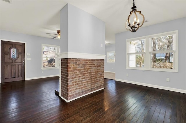 entryway featuring dark wood-type flooring and ceiling fan with notable chandelier