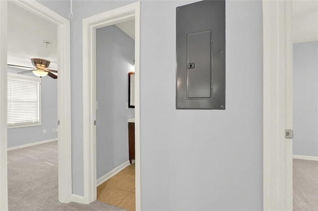 hall featuring light colored carpet and electric panel