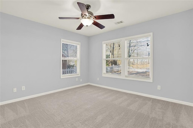 spare room featuring ceiling fan and carpet floors