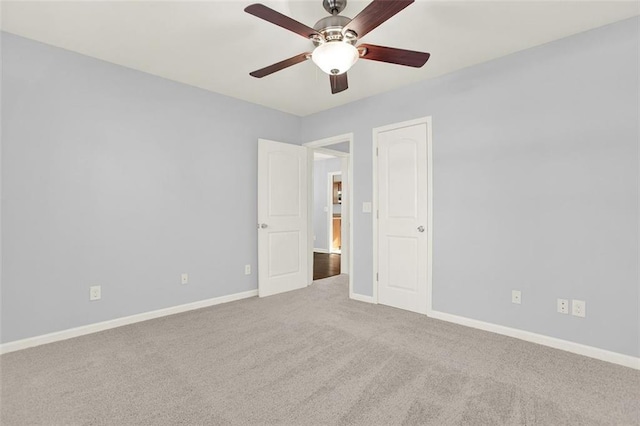 spare room featuring ceiling fan and light carpet