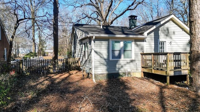 back of property with a wooden deck