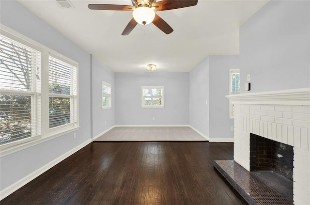 unfurnished living room with ceiling fan, dark hardwood / wood-style flooring, and a fireplace