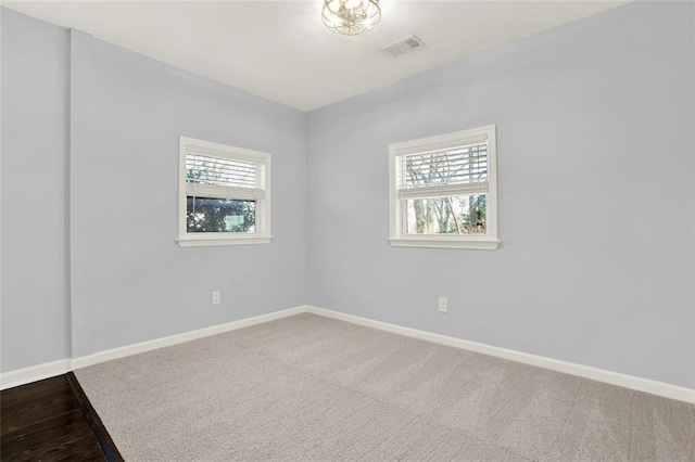 carpeted empty room with a healthy amount of sunlight