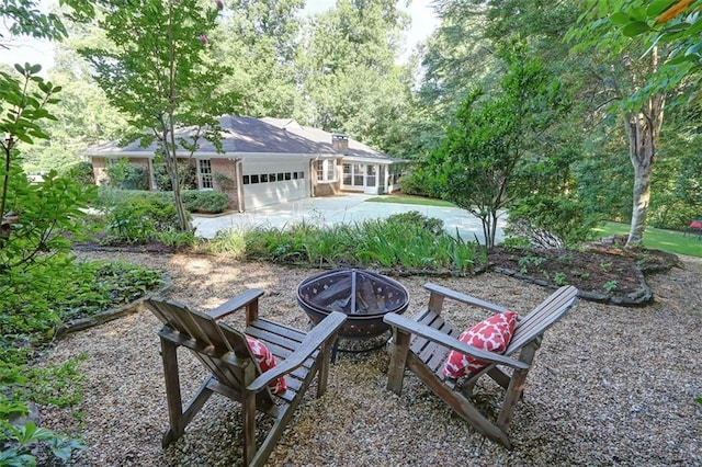 view of yard with a fire pit and a garage